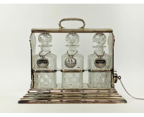 A WALKER AND HALL SILVER PLATED TANTALUS fitted with three square cut glass decanters, carrying handle to top, 32cm H x 38cm 