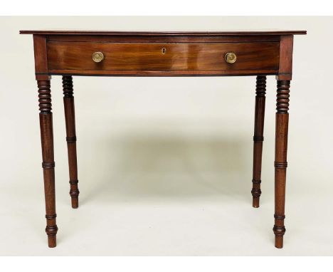 WRITING TABLE, George III bowfronted mahogany with a full width frieze drawer and ring turned tapering supports, 84cm W x 52c