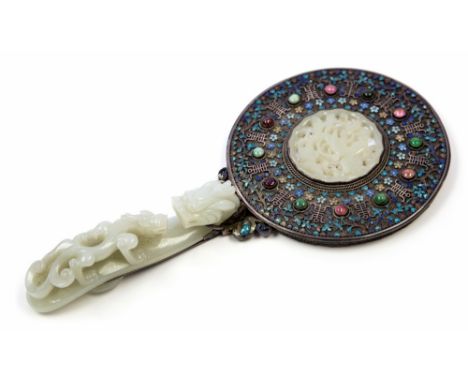 A Chinese jade and enamelled white metal hand mirror, incorporating a carved jade belt hook, modelled in the form of a reticu