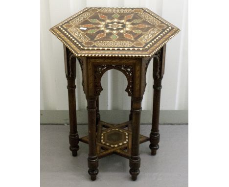 A Middle Eastern hexagonal occasional table, circa 1920, bone and specimen inlaid throughout, architectural stand, width 52cm