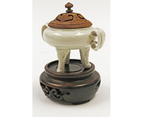 A small Dehua white porcelain tripod censer, Qing Dynasty, on elephants mask and trunk feet, supporting a squat ovoid body wi
