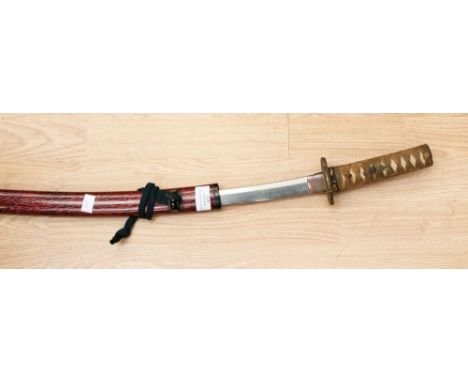 A wakisashi, 45cm blade and signed tang, grip covered with shagreen and bound with cloth containing two menuki, hamon just vi