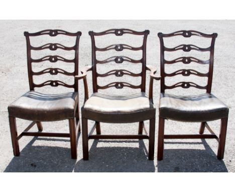 A George III style set of twelve mahogany dining chairs, in the manner of Thomas Chippendale, comprising two open armchairs a