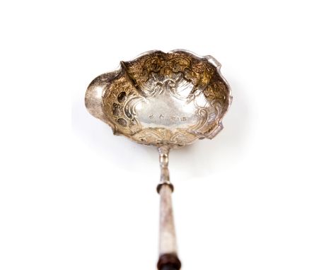 A George II silver punch ladle, Rococo form with chased scroll decoration (possibly later),on a twisted whalebone handle, Lon