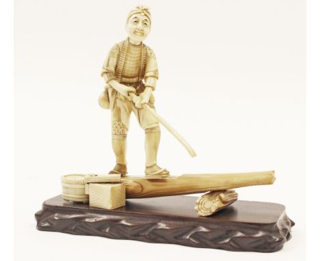 A Japanese Meiji sectional ivory okimono, fisherman standing balanced on a tree trunk, basket at his side, signed, height 17c