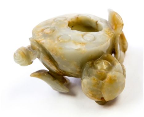 A Chinese carved jade vessel, the three feet modelled as a lotus leaf, flower and leaf with snail, 9cm diameter