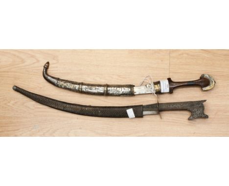 Two Middle Eastern daggers, to include an Arab jambiya of typical form, curved 21cm blade, distresed silver decorated scabbar