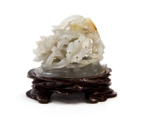 A Chinese jade hat finial, Qing Dynasty, of translucent greyish tone, carved as a mandarin duck, in its bill the stem of the 