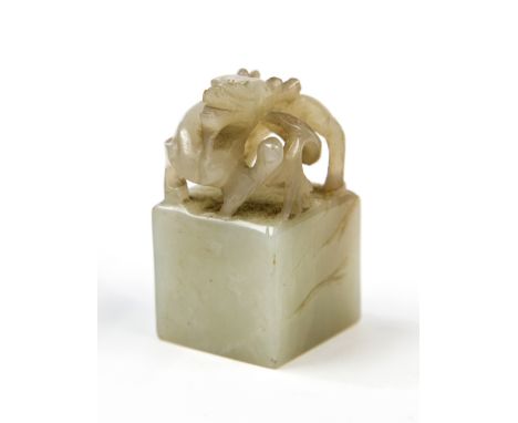 A Chinese carved jade seal, the top in the form of a dragon, 4.7cm high