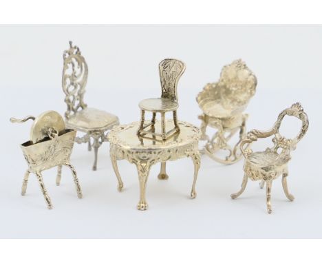 Six white metal miniatures comprising two sterling silver chairs with import marks for London 1897 and 1903, Chinese white me