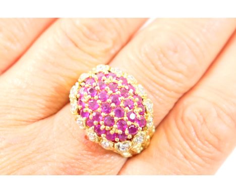 Ruby and diamond cluster dress ring, in 9ct gold, domed pave set rubies bordered with a single row of tiny diamonds, on textu