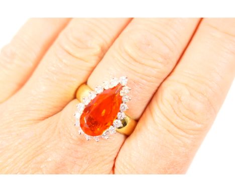 Attractive fire opal and diamond cluster ring, pear cut fire opal, approx. 15mm x 8mm, bordered with 19 small brilliant cut d