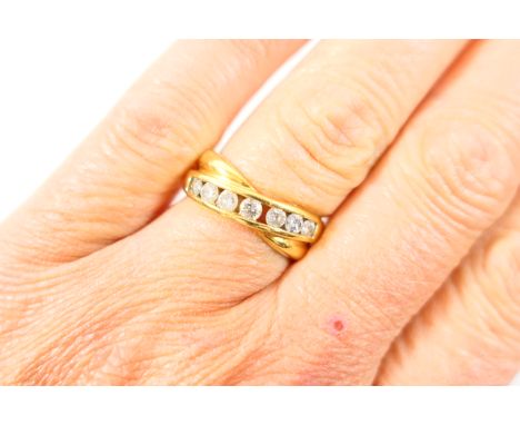 Diamond half eternity ring, set with seven small brilliant cut diamonds totalling approx. 0.5ct, in an open channel set 18ct 