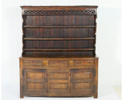 Early Georgian oak dresser and plate rack, circa 1720 and later, the moulded cornice with pierced lunette apron over three sh