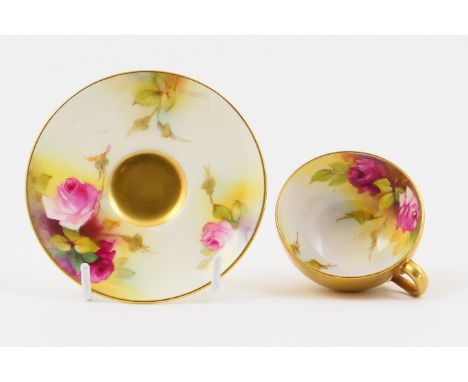 Royal Worcester cabinet cup and saucer, circa 1932, decorated with roses by Spilsbury, the cup with a gilded exterior, the sa