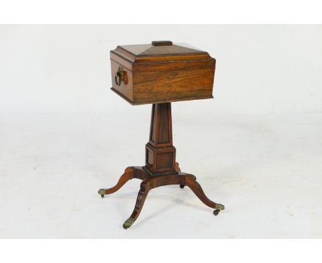 Good late Regency rosewood teapoy, circa 1815-25, the sarcophagus top with beaded edge and twin brass ring handles, opening t