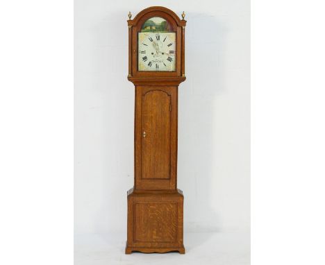 Oak eight day longcase clock by Ray, Bury St Edmunds, circa 1810-30, arched hood with brass urn finials, brass capped fluted 