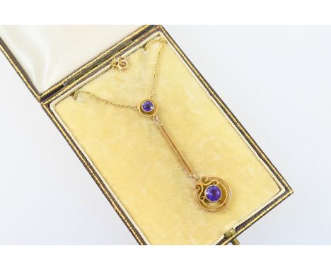 Edwardian amethyst pendant necklace, in 9ct gold, the pendant set with two round cut stones in beaded collet mounts, separate