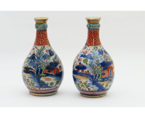 Pair of Chinese clobbered porcelain guglets, late 18th Century, decorated with a pavilion landscape in underglaze blue, later