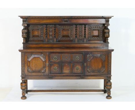 Carved oak sideboard in the Elizabethan Revival style, circa 1900-10, the back with a cornice supported on cup and cover supp