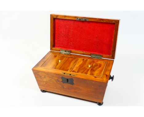 Regency yewood sarcophagus form tea caddy, circa 1820, inlaid with ebony stringing and with ebony escutcheon, opening to reve