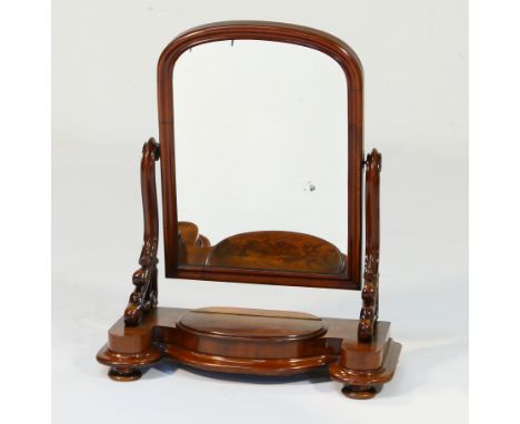 Victorian mahogany toilet mirror, circa 1860, arched rectangular plate supported on moulded, scrolled brackets, over a shaped