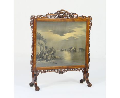 Oriental carved hardwood firescreen, early 20th Century, the frame surmounted with a carved scrolling dragon and fretwork tre