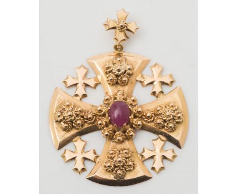 A cruciform pendant with central oval, cabochon ruby:, approximately 17gms gross weight. 