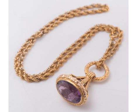 A gold and amethyst fob initialled 'R', on gilt metal, rope twist necklace:. 