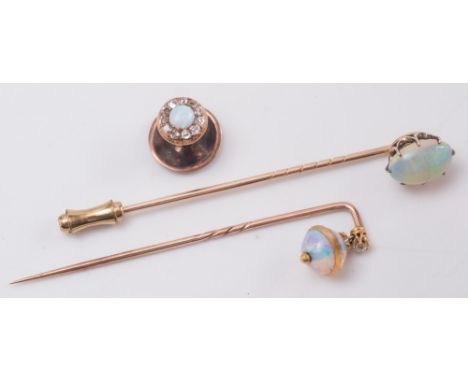 An oval opal single stone stick pin, a spherical opal and diamond stick pin and an opal and diamond dress stud:.  