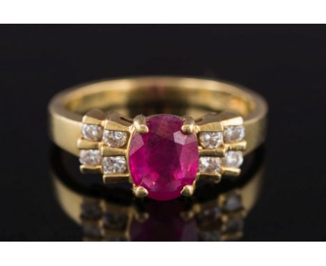 A modern ruby and diamond ring: with central oval ruby approximately 7.8mm x 6.1mm, estimated to weigh 1.2cts, in four claw s