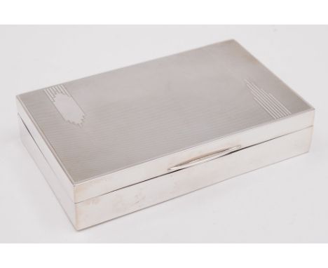 A George VI silver cigarette box, maker S. Ltd, Birmingham 1942:, with engine turned decoration, 15cm wide.