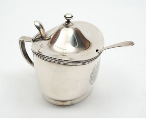 An Edward VII silver oval mustard pot, maker Garrard & Co, London, 1906: crested, within a foliate armorial surround with thr