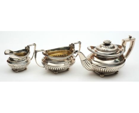  A George III antique silver three-piece oval tea set: with reeded lower bodies, gadroon edging, scroll and shell-capped angu