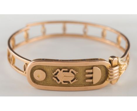 A broken gold Egyptian bangle with Hieroglyphics:, approximately 23gms gross weight. 