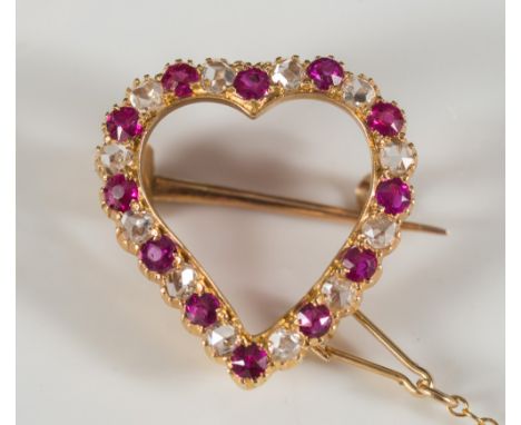 A gold, ruby and rose diamond mounted heart shaped brooch:. 
