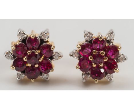 A pair of ruby and diamond circular cluster ear-studs with butterfly scrolls stamped '585':.