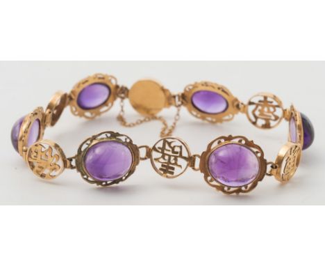 An amethyst and '14K' stamped bracelet: with oval cabochon amethysts between circular panels with applied Chinese characters.