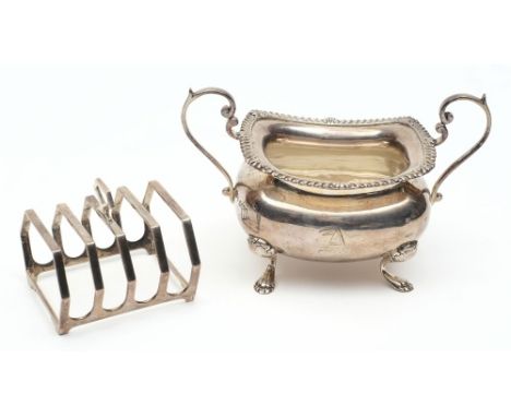 A silver twin handled sugar basin, all marks worn, Sheffield, : initialled, with gadrooned border and raised on four paw feet