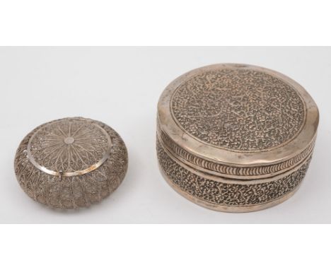 An Indian silver circular trinket box and cover: with trailing foliate decoration, 9cm. diameter, together with a silver fili
