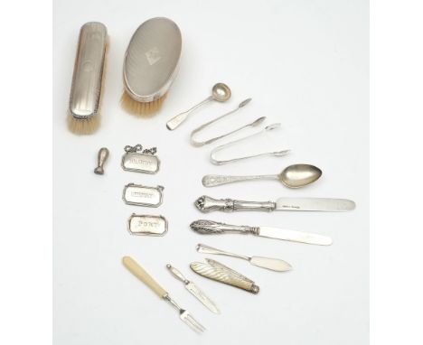 Two silver backed brushes: three silver wine labels, and assorted flatware, various makers and dates.
