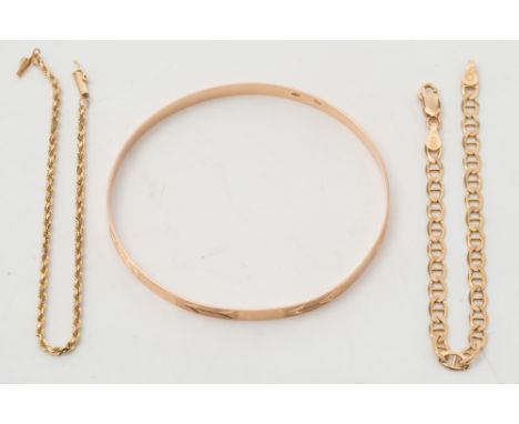 A rope-twist bracelet stamped '14K', another bracelet stamped '14KT' and a yellow metal bangle: possibly stamped '750'. 