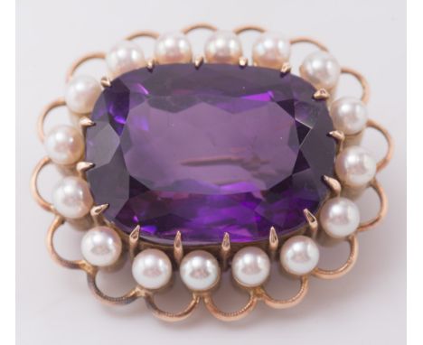 An amethyst and cultured seed pearl oval brooch:, the rectangular amethyst approximately 22mm long x 16mm wide, within a surr