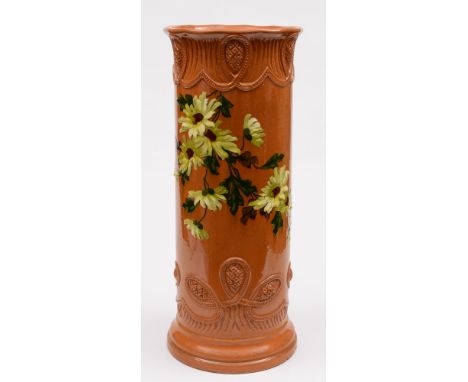 A Burmantofts pottery stick stand: of moulded cylindrical form impasto decorated with daisy-like blooms between bands of stra