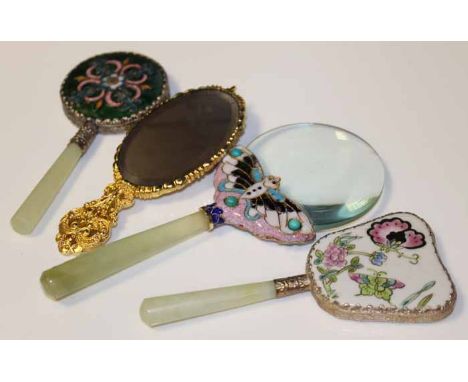 TWO MODERN CHINESE JADE HANDLED HAND MIRRORS
together with a jade handled magnifying glass, each decorated with enamel, the m