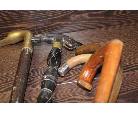 FIVE WALKING STICKS
including a silver topped walking stick