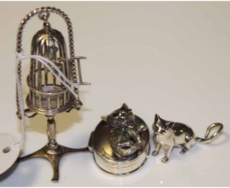 COLLECTION OF MODERN SILVER COLLECTABLES
including a miniature silver cat ornament, a silver bird cage with a canary inside a