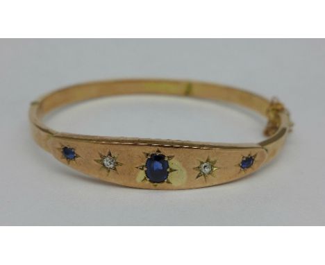 A 9ct gold, diamond and sapphire bangle, 8.5g