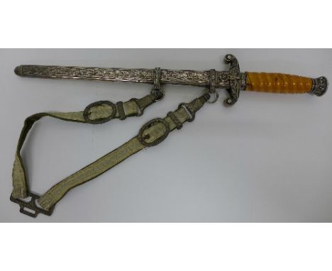 A German dagger with scabbard, the blade marked F.W. Höller, Solingen, the metal on the strap marked D.R.G.M., handle a/f