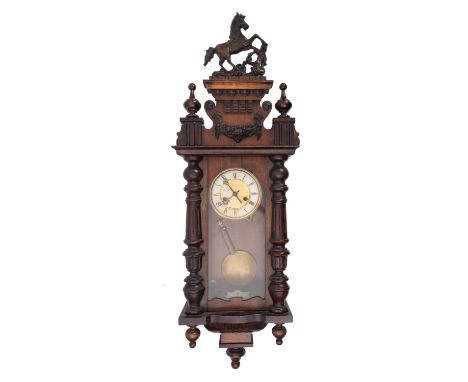 A Vienna-style German wall clock having an eight-day duration movement striking the hours and half-hours on a gong and stampe